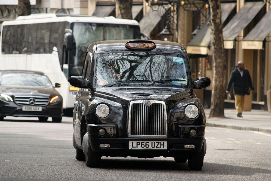 A traditional black cab taxi on a London street